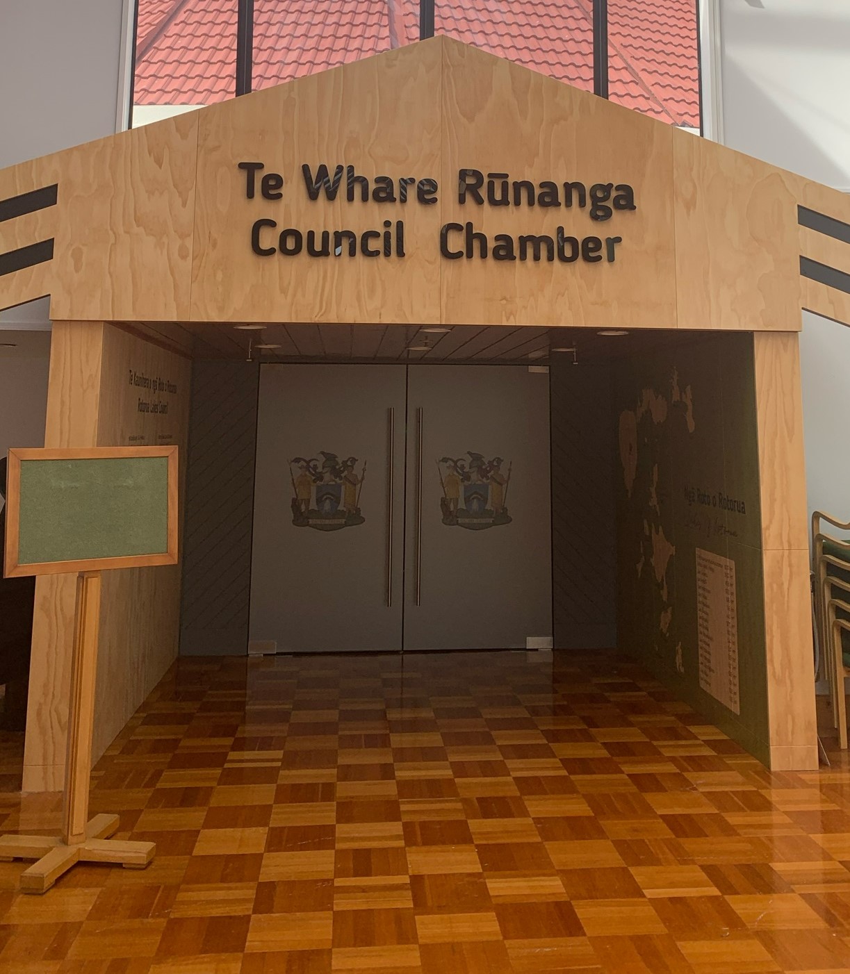 Photo of a Council Chamber highlighting bilingual signage with te reo Māori at the top and English at the bottom